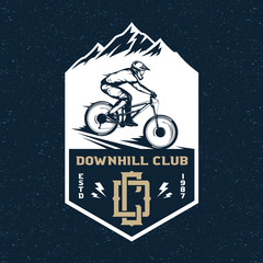 Vector downhill mountain biking badge, logo, label with rider on a bike and mountain silhouette. Downhill, enduro, cross-country biking illustration