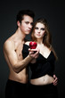 © YouraPechkin - Young beautiful loving sexy couple standing and looking to each other over dark grey background