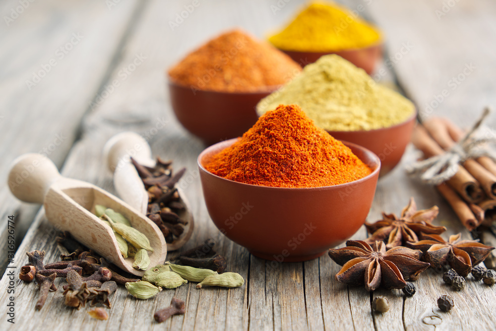 Aromatic spices and herbs: red pepper, turmeric, cardamom, cinnamon, cloves, anise, paprika. Ingredients for cooking. Ayurveda treatments - obrazy, fototapety, plakaty 
