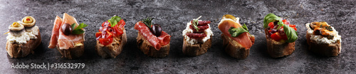 Fotomural Appetizers table with italian antipasti snacks and wine in glasses