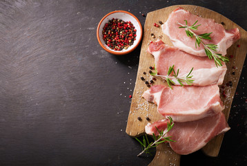 Wall Mural - fresh pork chops with rosemary and spices, top view