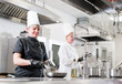 © Andrey - cook preparing dinner in a restaurant kitchen.