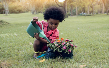 African boy is playing in the garden