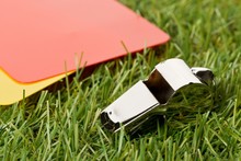 Soccer Sports Referee Yellow And Red Cards With Chrome Whistle On Grass Background Selective Focus