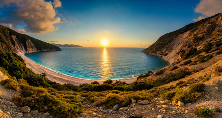beautiful summer sunset on mirtos beach in greece - panorama