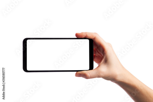 Cuadros en Lienzo Woman holding smartphone with empty screen isolated on white background