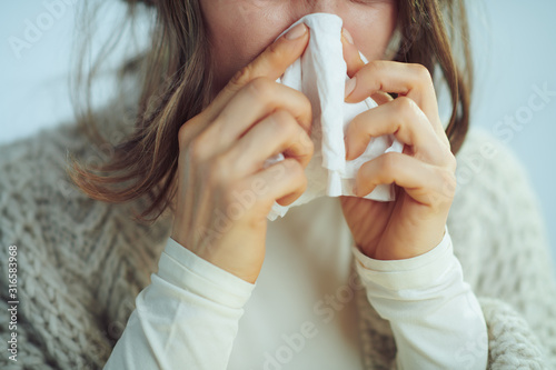 Fotomural Closeup on ill elegant woman wiping nose with napkin