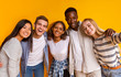 © Prostock-studio - Friendly international students taking selfie over yellow background