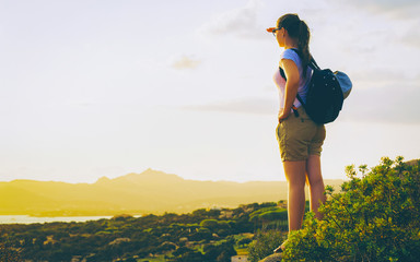 Wall Mural - Sunrise or sunset and young girl at Baja Sardinia of at Mediterranean sea in Sardinia island in Italy. Woman and Sardegna in summer.