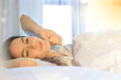 © Natalia - Young girl just wake up in her bed in the morning, listening to music and smiling.
