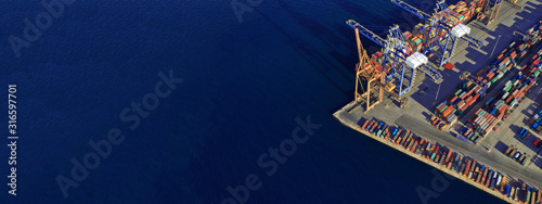 Cuadros en Lienzo Aerial drone ultra wide top down photo of commercial container terminal with cra