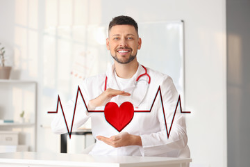 Male cardiologist with drawn heart and cardiogram in modern clinic