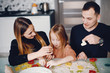 © hetmanstock2 - Family in a kitchen. Little girl with a dough.