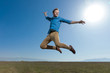 © Viorel Sima - casual man wearing blue shirt jumping high to the sky