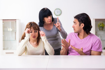 Wall Mural - Young family and mother-in-law in family issues concept