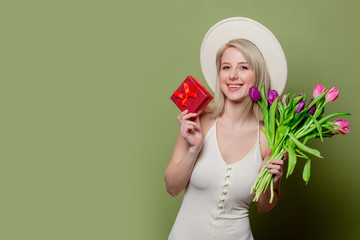 Wall Mural - Beautiful blonde girl with tulips and gift box