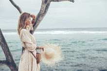 Boho Model Wearing Dress And Straw Hat On The Beach