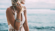 © Alena Ozerova - Boho model wearing crochet top and silver jewelry on the beach
