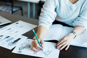 Woman working on fashion sketch design