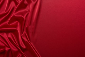 Abstract background from red silk or satin. Luxury fabric texture with draped. Copy space. Element design. Valentine's day.
