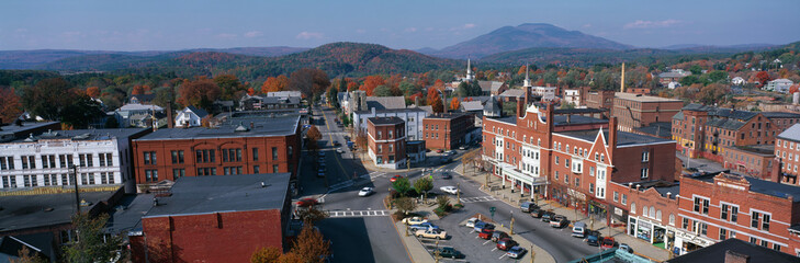 Wall Mural - This is a panorama view from the Bell Tower in Claremont. It shows a typical scene from small town America. The buildings are mostly made from red brick. We see fall foliage in the background.