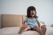 © Odua Images - Strong screaming due to a tantrum. child crying on bed