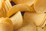 Fototapeta Do przedpokoju - Delicious potato chips, laying on wooden table background