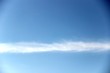 bright blue sky and a strip of clouds horizontally. spring, blue sky with a thin strip of clouds