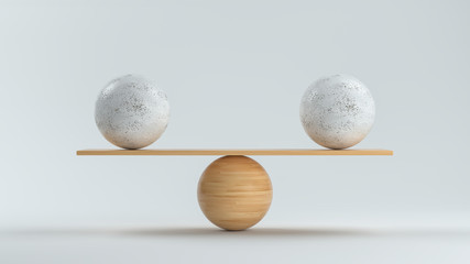 wooden scale balancing two big balls in front white background