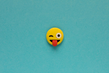 Wall Mural - Yellow funny smiley face on blue background. Positive mood concept.