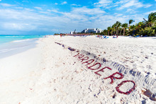 VARADERO Written On A Sandy Beach As Ocean. Varadero, Cuba. Name Of The Resort Town On White Sand Lined With Seaweed