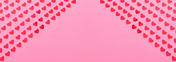 Wall Mural - Valentines day concept. red hearts over wooden pink background. Flat lay composition