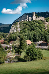 Wall Mural - romantic castle on top of a hill in a mountainous valley