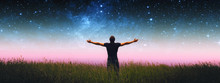 Man With Arms Wide Open Standing On The Grass Field Against The Night Starry Sky. Elements Of This Image Furnished By NASA.