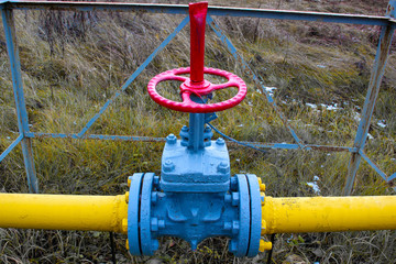 Vintage red gas tap. Gas valve,Gas pipeline. Oil and gas industry concept. Industrial site background.