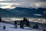 Fototapeta Niebo - Winter forest in dramatic sunrise in the Carpathians, Romania.