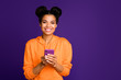 © deagreez - Photo of cheerful positive toothy beaming cute nice pretty woman with telephone held hands standing near empty space looking at you isolated vivid purple color background