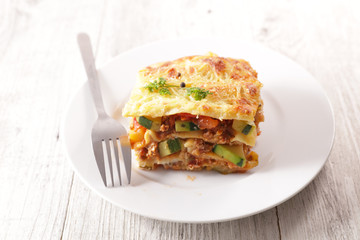 Canvas Print - plate of lasagna with minced beef, tomato sauce and vegetable