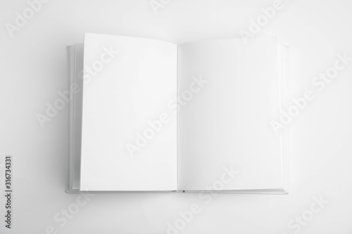 Fotomural Open book with blank pages on white background, top view