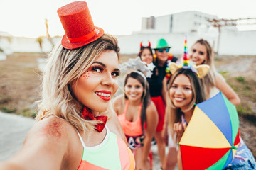 Wall Mural - Brazilian Carnival. Group of friends in costumes taking a self portrait