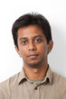 © MDBPIXS - Portrait of young Indian man against white background