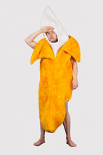 Tired Man In Banana Costume Against Gray Background