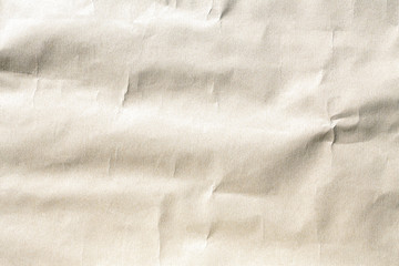 Old pale brown crumpled paper background texture