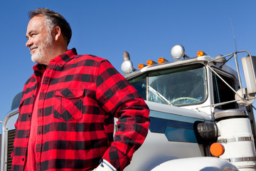 Trucker standing in front of Cargo truck