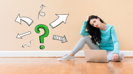 Wall Mural - Question mark with arrows with young woman using a laptop computer