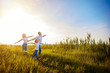 © ZaStock - Photo A happy family in white T-shirts, sunglasses and jeans in the park spread apart arms mimicking airplanes. Summer. Vacation air travel concept.