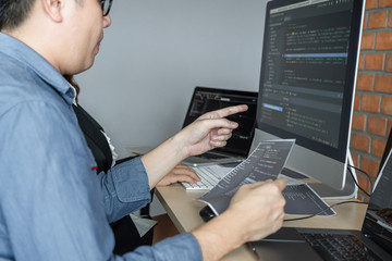 Leinwandbilder - Two professional programmer cooperating and working on web site project in a software developing on desktop computer at company, codes and typing data code, Programming with HTML, PHP and javascript