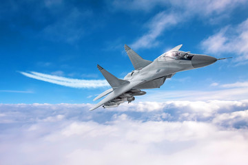 Poster - Military airplane speed flies with a smoky train low above the clouds.