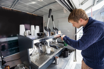 Wall Mural - Side view of man working at mobile coffee shop