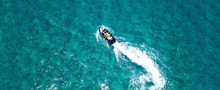 Aerial Drone Ultra Wide Photo Of Jet Ski Couple Cruising In High Speed In Tropical Exotic Bay With Emerald Sea